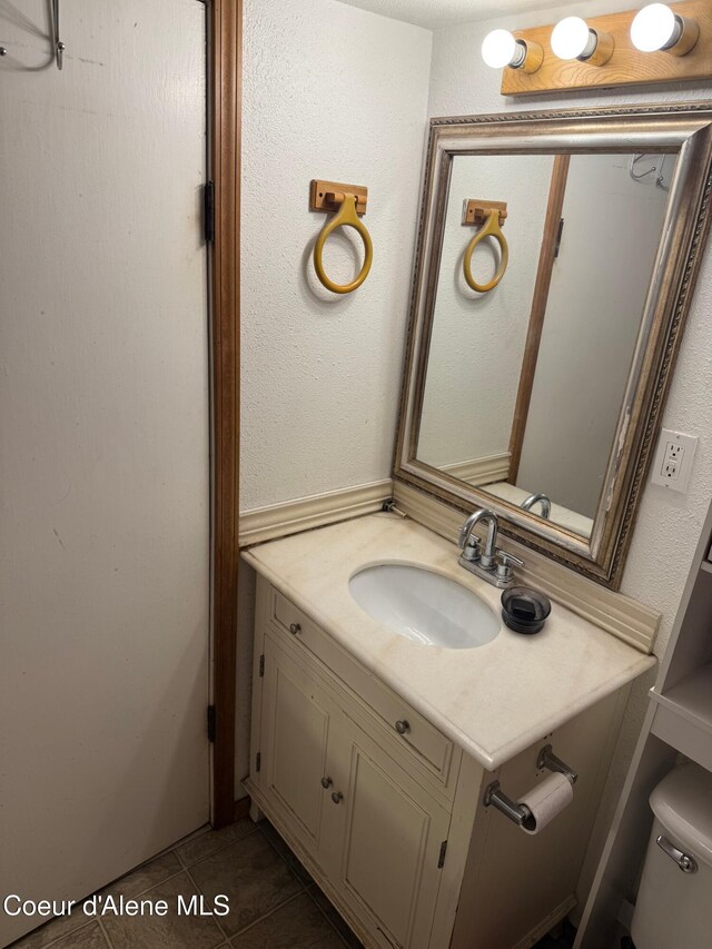 30625 Pastime St, Athol, ID 83801 - bathroom with vanity, toilet, and tile patterned floors