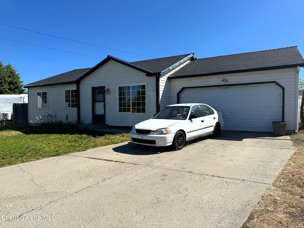 1009 E Shasta Ave, Post Falls, ID 83854 - single story home featuring concrete driveway, an attached garage, and a front yard