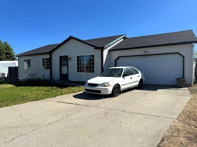 1009 E Shasta Ave, Post Falls, ID 83854 - single story home featuring concrete driveway, an attached garage, and a front yard
