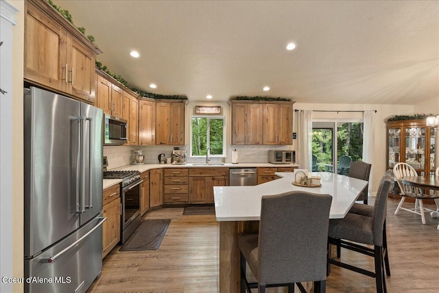 12671 E Trout Pond Rd, Athol, ID 83801 - kitchen featuring stainless steel appliances, healthy amount of natural light, light countertops, tasteful backsplash, and recessed lighting