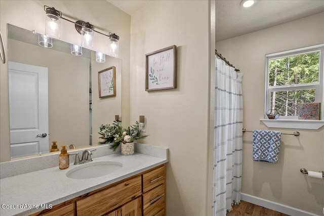 12671 E Trout Pond Rd, Athol, ID 83801 - full bathroom with vanity, wood finished floors, and a shower with shower curtain