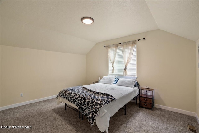 12671 E Trout Pond Rd, Athol, ID 83801 - bedroom featuring vaulted ceiling, carpet, baseboards, and a textured ceiling