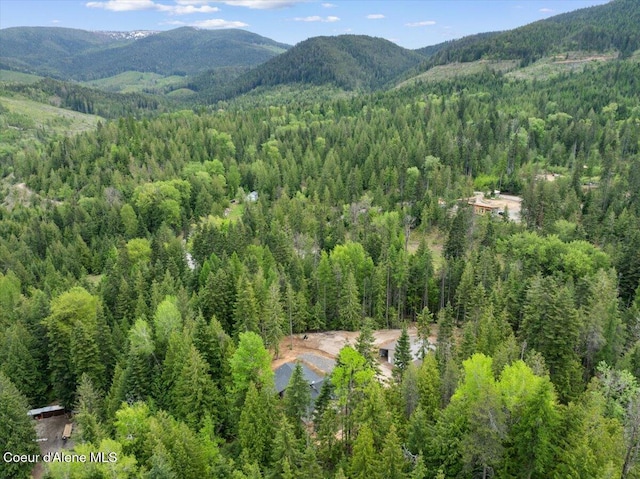 12671 E Trout Pond Rd, Athol, ID 83801 - aerial view of a heavily wooded area and a mountain backdrop