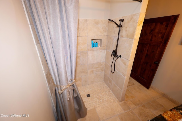 9057 W Benton Way, Coeur Dalene, ID 83814 - full bathroom featuring a tile shower and stone finish floors