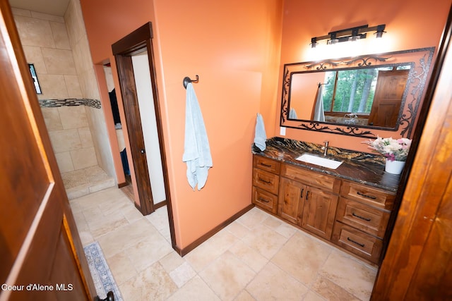 9057 W Benton Way, Coeur Dalene, ID 83814 - bathroom with vanity, tiled shower, and baseboards
