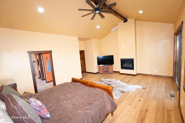 9057 W Benton Way, Coeur Dalene, ID 83814 - bedroom featuring beamed ceiling, light wood-style floors, a glass covered fireplace, recessed lighting, and high vaulted ceiling