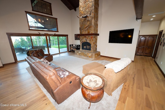 9057 W Benton Way, Coeur Dalene, ID 83814 - living room with high vaulted ceiling, wood finished floors, beam ceiling, baseboards, and a fireplace