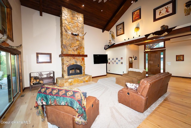9057 W Benton Way, Coeur Dalene, ID 83814 - living area with wooden ceiling, wood finished floors, high vaulted ceiling, baseboards, and a stone fireplace