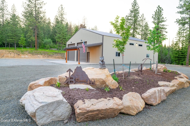 9057 W Benton Way, Coeur Dalene, ID 83814 - view of front of property with a detached garage, an outbuilding, and a pole building