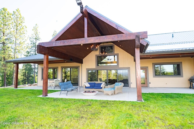 9057 W Benton Way, Coeur Dalene, ID 83814 - rear view of property featuring an outdoor hangout area, a patio, metal roof, and a yard