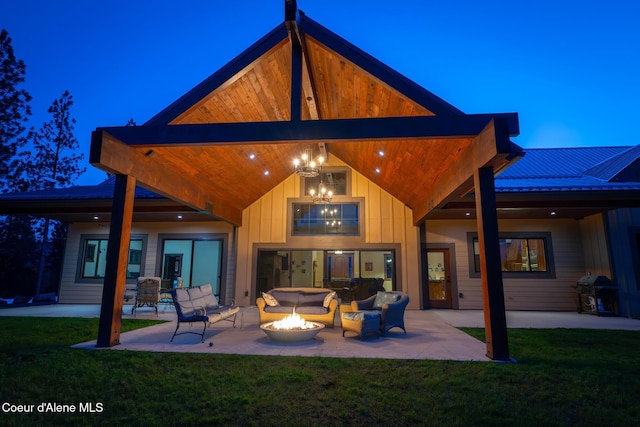 9057 W Benton Way, Coeur Dalene, ID 83814 - back of house featuring a patio, a lawn, and an outdoor living space with a fire pit