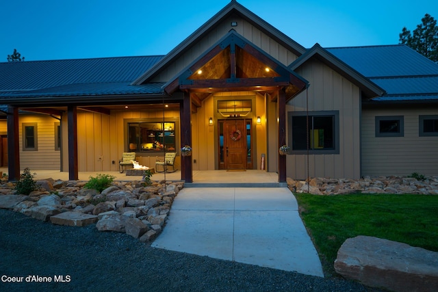 9057 W Benton Way, Coeur Dalene, ID 83814 - entrance to property featuring board and batten siding, metal roof, and a yard