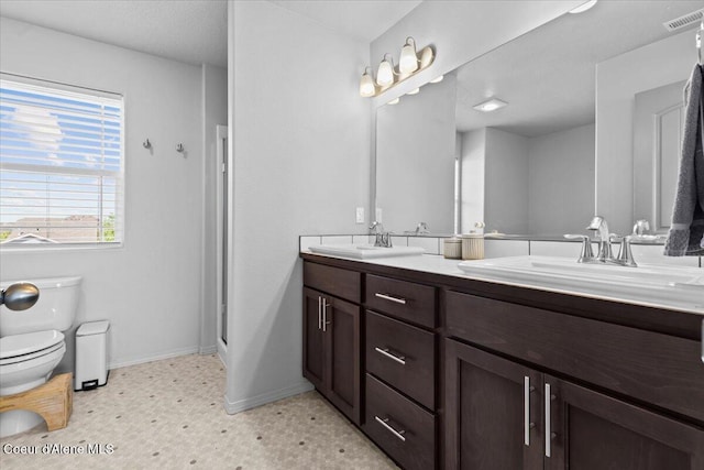 1482 N Skykomish Dr, Post Falls, ID 83854 - full bathroom with toilet, tile patterned floors, double vanity, and baseboards