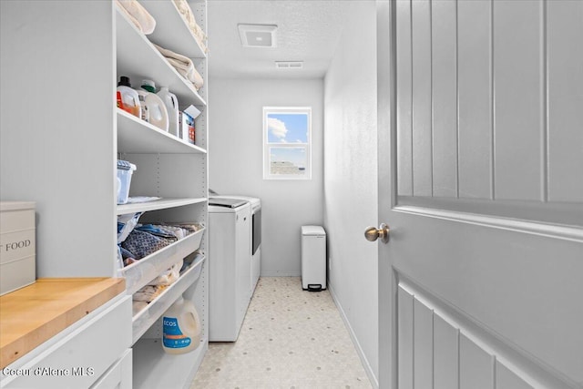 1482 N Skykomish Dr, Post Falls, ID 83854 - washroom with baseboards, washing machine and clothes dryer, light flooring, and a textured ceiling