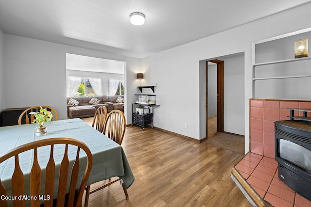 5739 W Maine St, Spirit Lake, ID 83869 - dining room featuring a wood stove and wood finished floors