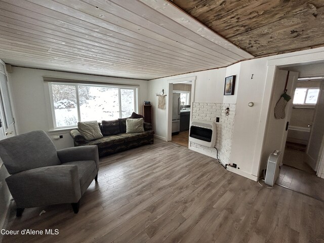 537 Pine St, Mullan, ID 83846 - living room featuring wood ceiling, heating unit, and hardwood / wood-style floors