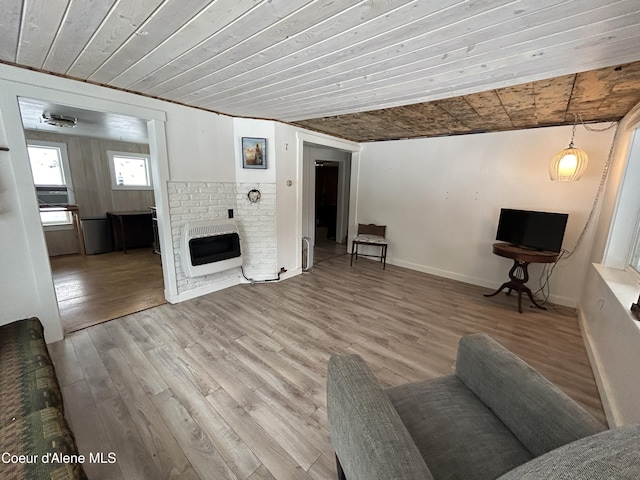 537 Pine St, Mullan, ID 83846 - living area featuring heating unit, wood ceiling, wood finished floors, a fireplace, and baseboards