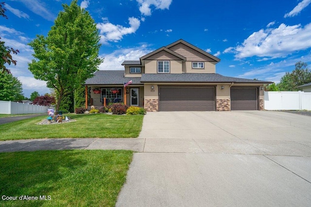 8558 N Boysenberry Loop, Hayden, ID 83835 - view of front facade featuring driveway, stone siding, a garage, and an attached garage