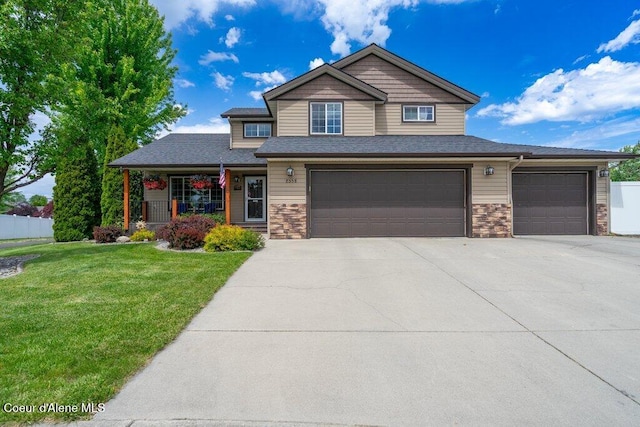 8558 N Boysenberry Loop, Hayden, ID 83835 - craftsman inspired home featuring concrete driveway, covered porch, stone siding, and a garage
