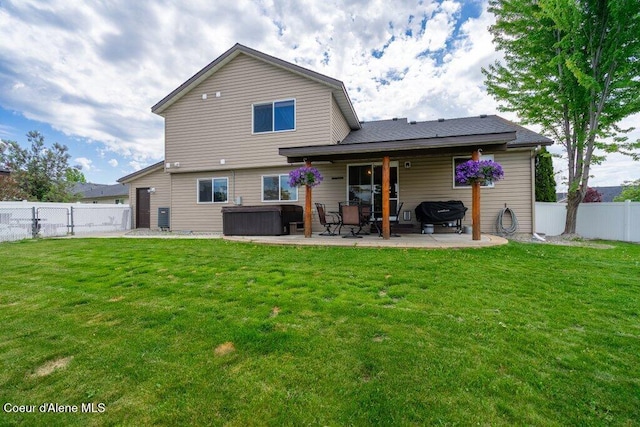 8558 N Boysenberry Loop, Hayden, ID 83835 - back of house with a hot tub and a patio