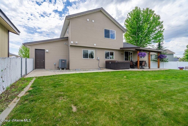 8558 N Boysenberry Loop, Hayden, ID 83835 - rear view of house with a hot tub, a patio area, and central AC unit
