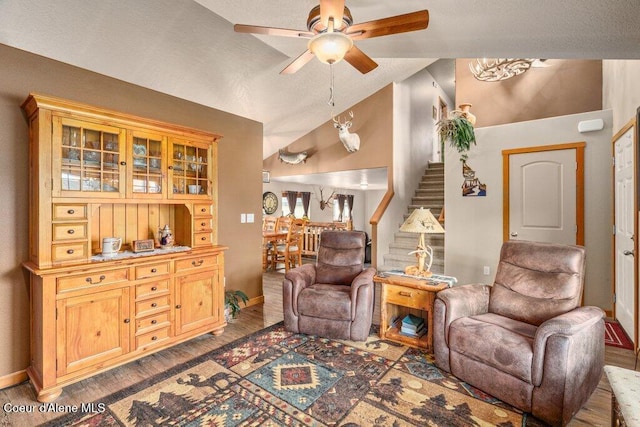 8558 N Boysenberry Loop, Hayden, ID 83835 - living area with vaulted ceiling, stairway, ceiling fan, wood finished floors, and baseboards