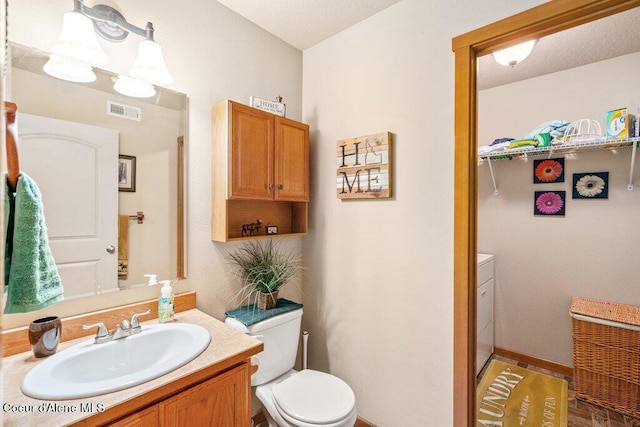 8558 N Boysenberry Loop, Hayden, ID 83835 - bathroom with vanity, toilet, and baseboards