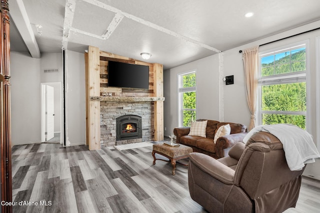 1446 Sagle Creek Rd, Sagle, ID 83860 - living room featuring wood finished floors, a stone fireplace, and recessed lighting