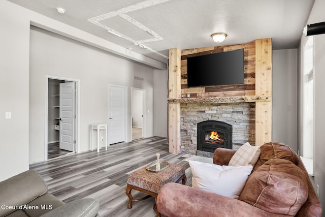 1446 Sagle Creek Rd, Sagle, ID 83860 - living room with wood finished floors, attic access, and a stone fireplace