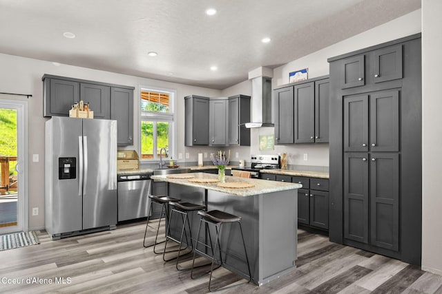 1446 Sagle Creek Rd, Sagle, ID 83860 - kitchen with stainless steel appliances, wall chimney range hood, light wood-type flooring, healthy amount of natural light, and recessed lighting