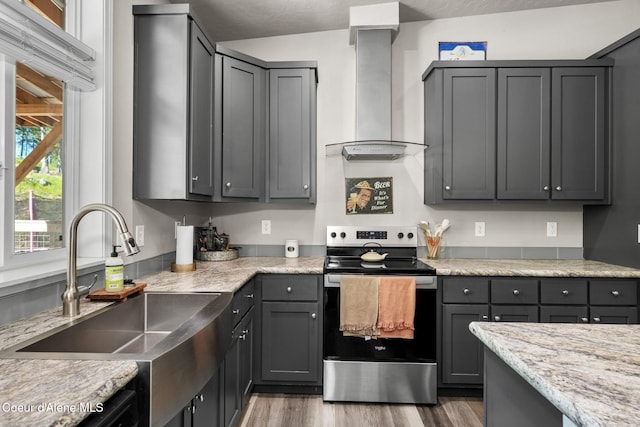 1446 Sagle Creek Rd, Sagle, ID 83860 - kitchen featuring stainless steel range with electric stovetop, a sink, wall chimney exhaust hood, wood finished floors, and gray cabinetry