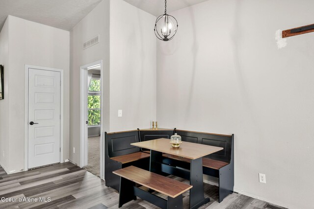 1446 Sagle Creek Rd, Sagle, ID 83860 - dining space featuring a chandelier, wood finished floors, and baseboards