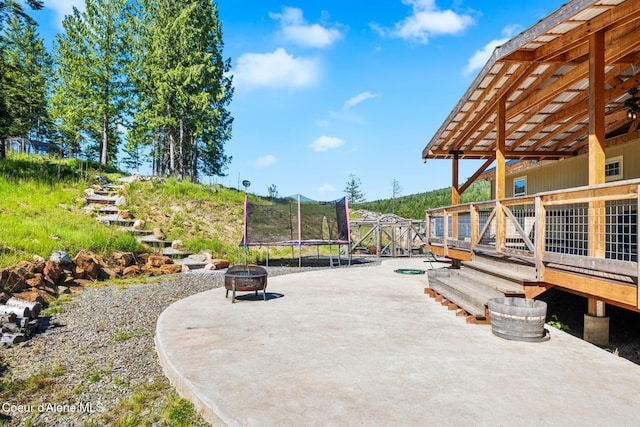 1446 Sagle Creek Rd, Sagle, ID 83860 - view of patio / terrace featuring a wooden deck, a trampoline, and an outdoor fire pit