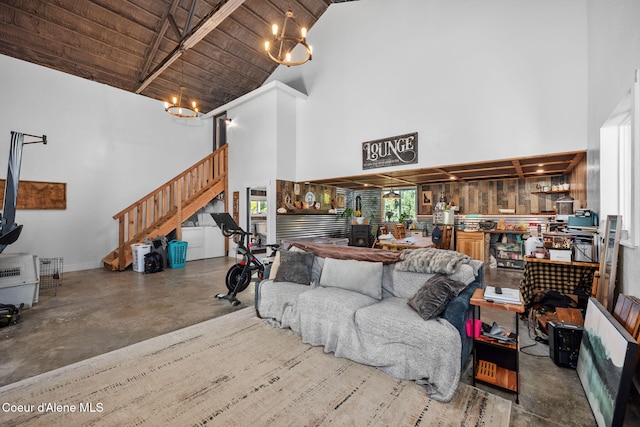 1446 Sagle Creek Rd, Sagle, ID 83860 - living area with high vaulted ceiling, a chandelier, concrete flooring, wooden ceiling, and stairway