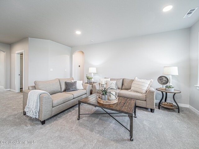 13668 N Apex Way, Hayden, ID 83835 - living room featuring arched walkways, light carpet, baseboards, and recessed lighting