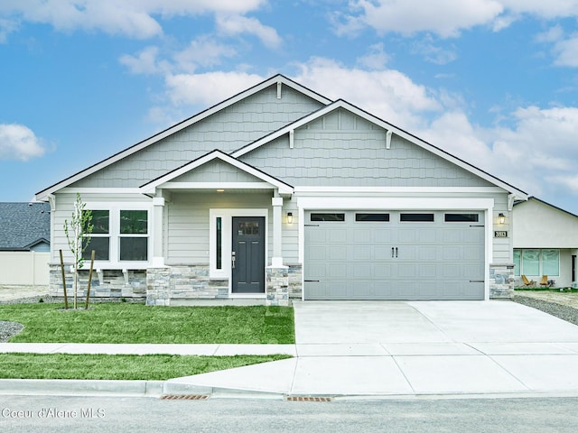 13668 N Apex Way, Hayden, ID 83835 - craftsman-style home with stone siding, a garage, driveway, and a front yard