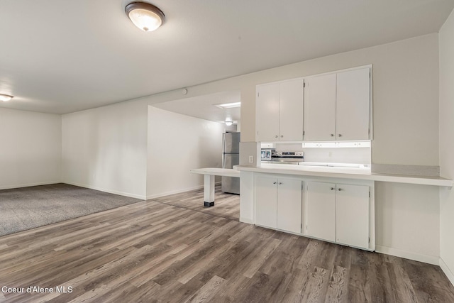 1611 E Birch St, Coeur Dalene, ID 83814 - kitchen featuring appliances with stainless steel finishes, wood finished floors, light countertops, white cabinetry, and baseboards