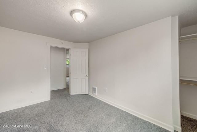 1611 E Birch St, Coeur Dalene, ID 83814 - unfurnished bedroom featuring carpet, baseboards, and a textured ceiling