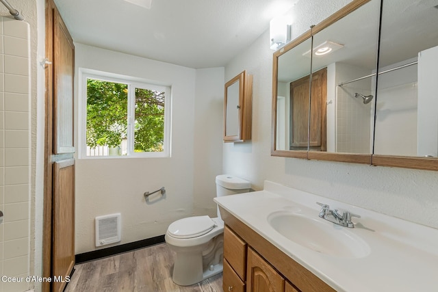 1611 E Birch St, Coeur Dalene, ID 83814 - full bathroom featuring wood finished floors, heating unit, vanity, toilet, and a shower