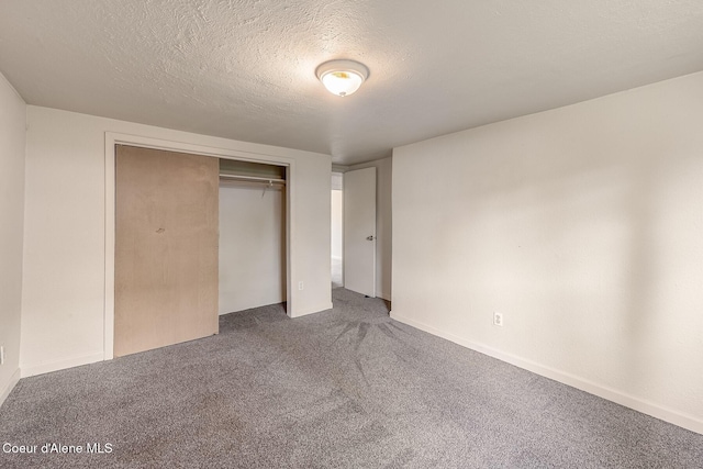 1611 E Birch St, Coeur Dalene, ID 83814 - unfurnished bedroom featuring carpet flooring, a closet, a textured ceiling, and baseboards