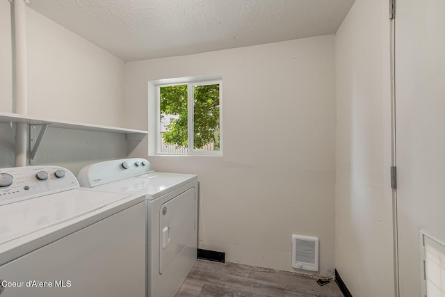 1611 E Birch St, Coeur Dalene, ID 83814 - washroom featuring wood finished floors, independent washer and dryer, and heating unit