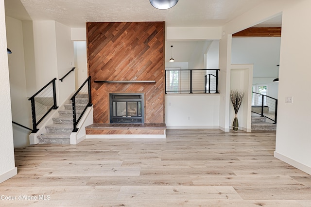 3809 N Moccasin Rd, Coeur Dalene, ID 83815 - unfurnished living room featuring wood finished floors, baseboards, and a fireplace