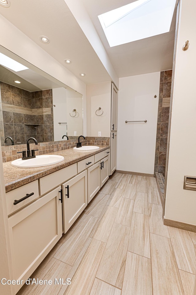 3809 N Moccasin Rd, Coeur Dalene, ID 83815 - bathroom with a skylight, double vanity, tiled shower, recessed lighting, and decorative backsplash