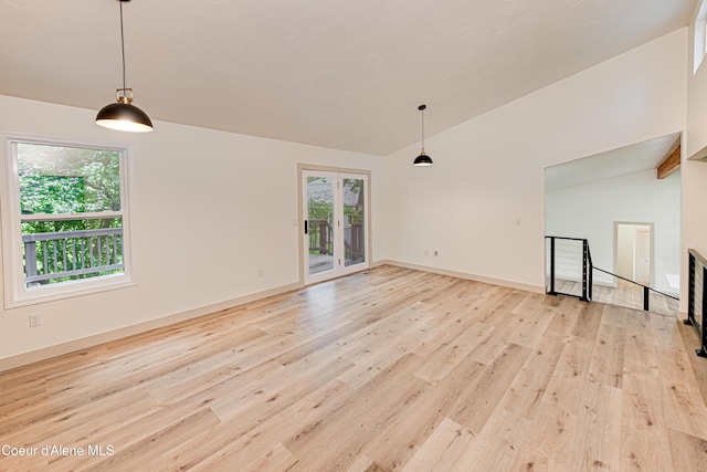 3809 N Moccasin Rd, Coeur Dalene, ID 83815 - unfurnished living room with lofted ceiling, light wood-type flooring, and baseboards