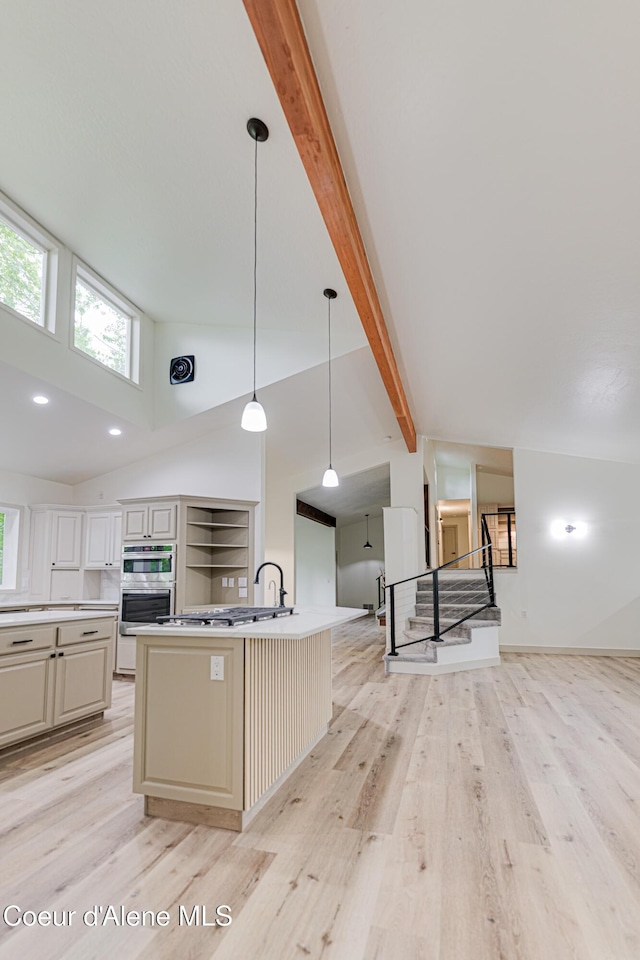 3809 N Moccasin Rd, Coeur Dalene, ID 83815 - kitchen featuring light wood-style floors, open floor plan, high vaulted ceiling, plenty of natural light, and beamed ceiling