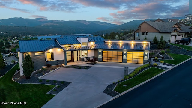 175 N Holidays Hills Dr, Liberty Lake, WA 99019 - view of front of home with a standing seam roof, a garage, a mountain view, and concrete driveway