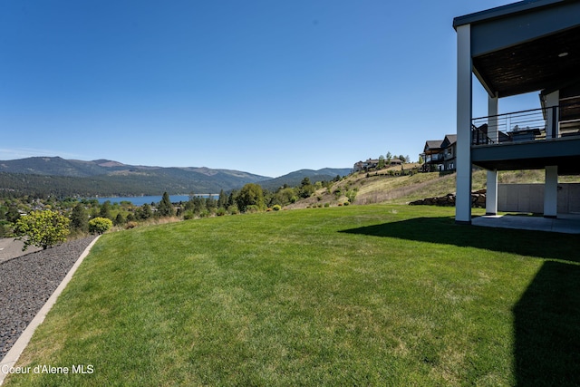 175 N Holidays Hills Dr, Liberty Lake, WA 99019 - view of grassy yard with a balcony and a water and mountain view