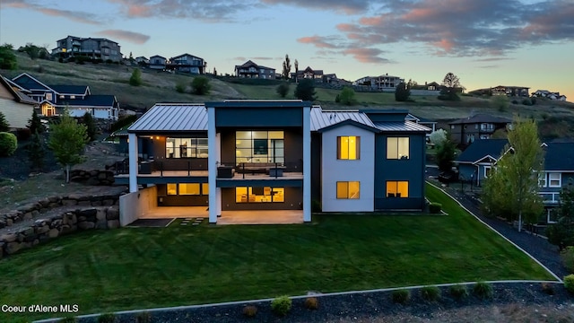175 N Holidays Hills Dr, Liberty Lake, WA 99019 - back of house with a standing seam roof, a balcony, a patio area, and a yard