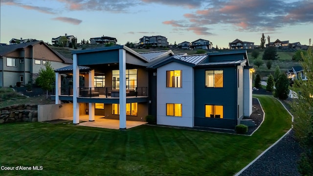 175 N Holidays Hills Dr, Liberty Lake, WA 99019 - rear view of property with a standing seam roof, a patio, a yard, and metal roof