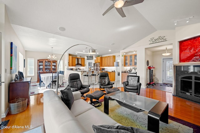 30587 S Sunray Trl, Worley, ID 83876 - living area featuring light wood-style flooring, lofted ceiling, a ceiling fan, a chandelier, and healthy amount of natural light